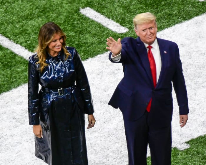 President Donald Trump stands with first lady Melania Trump on the field of the College Football Playoff final